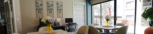 A dining room with a table and chairs.