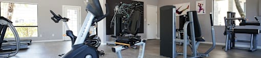 A home gym with a variety of exercise equipment.