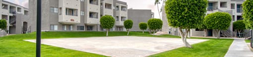 El Encanto sports court with lush landscape surounding