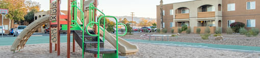 Tanglewood view of park with slide and sand around