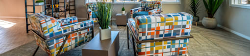 A living room with two chairs and a table.