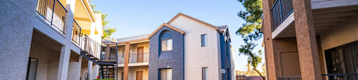 A sunny day at a residential complex with a clear blue sky.
