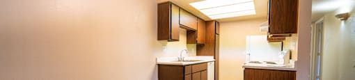 A kitchen with wooden floors and white walls.