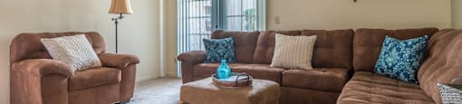 Somerpointe living room with plenty of couches and lounging space with carpet flooring