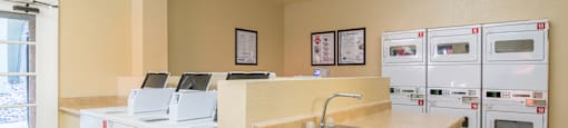 Laundry room with washers and dryers and sink