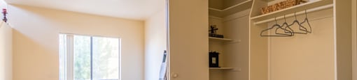 Living room with window and vinyl flooring with large closet