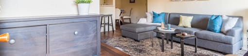 Enclave living room with cozy couches and wood-like flooring