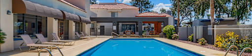 a swimming pool with a house in the background