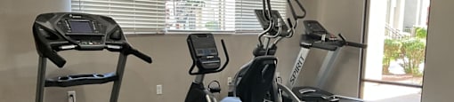 a gym with treadmills and ellipticals