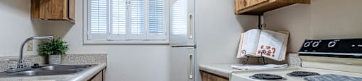 a kitchen with a stove refrigerator and sink