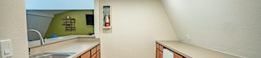 a kitchen with wooden cabinets and a sink and a mirror