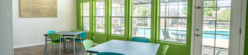a dining room with a table and chairs and a pool