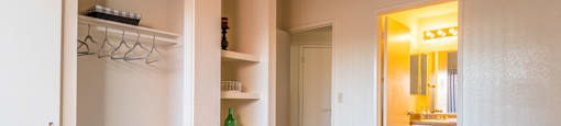 Bedroom with large closet and well lit bathroom