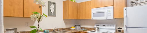 Desert Sands kitchen equipped with all white appliances.