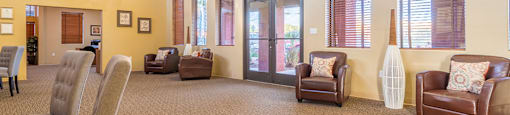 Enclave view of clubhouse with lounge area and wonderful lighting
