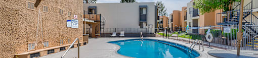 our apartments have a large pool and patio with umbrellas