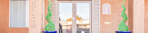 Tanglewood  clubhouse entrance with well kept path and glass doors