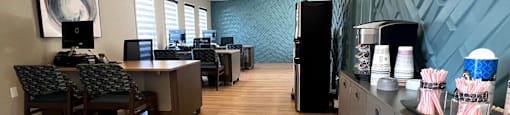 an office with a blue accent wall and wood flooring