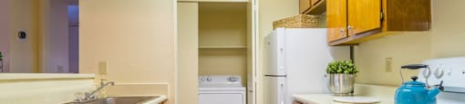 Enclave kitchen with plenty of cabinetry, a fridge, a sink, and dishwasher