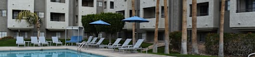 El Encanto refreshing pool with lounge chairs.