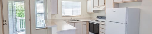 a kitchen with white cabinets and white appliances