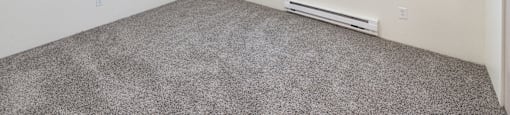 a bedroom with white walls and carpet