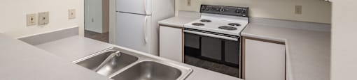 a kitchen with white cabinetry and white appliances