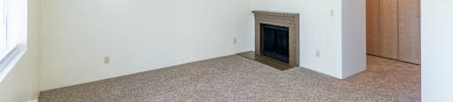 a living room with white walls and a fireplace