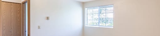 a bedroom with carpet and a window