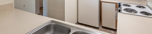 a kitchen with white appliances and white cabinets