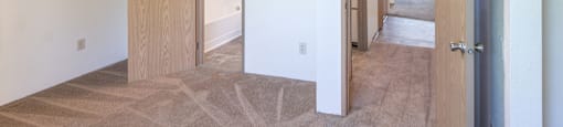a view of a bedroom and hallway from the living room
