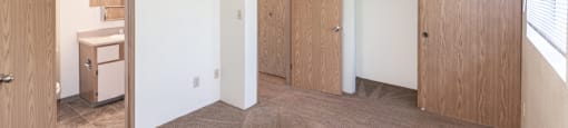 a bedroom with white walls and a carpeted floor