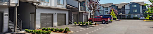 a row of houses with a red truck parked in a parking lot