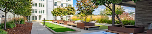 A ping pong table is in the middle of a courtyard.