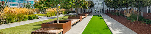 A modern building with a green lawn in front.