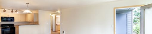 a large living room with a kitchen in the background