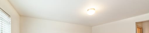 a bedroom with white walls and carpet