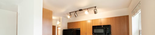 a kitchen with wood cabinets and black appliances