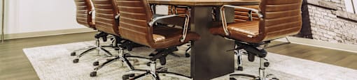 a conference room with a table and chairs and a tv at The Mill at Prattville, Prattville, Alabama