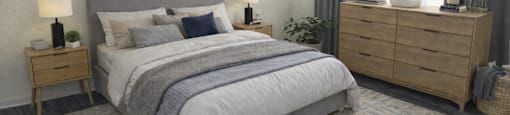A bedroom with a large bed, a nightstand, and a dresser.