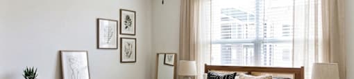A bedroom with a bed, nightstands, and a ceiling fan.