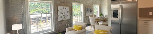 A modern living room with a white sofa, yellow pillows, and a coffee table.