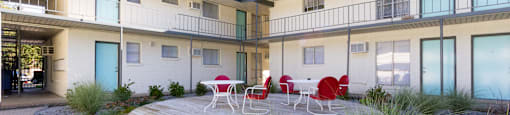 a courtyard with a table and chairs in front of a building at The Junction, Tennessee, 38111