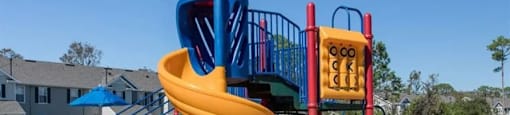 a playground with a yellow and blue slide