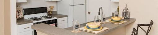 a kitchen with a counter top and a stove top oven