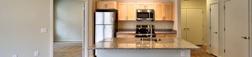 A modern kitchen with a large island in the middle.