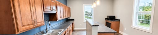 A kitchen with wooden cabinets and a black countertop.