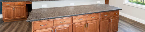 A kitchen with wooden cabinets and a granite countertop.
