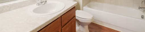 A white sink is on a countertop in a bathroom.