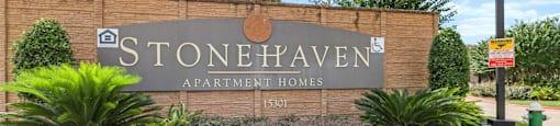 Stonehaven Apartment Homes sign in front of a building.